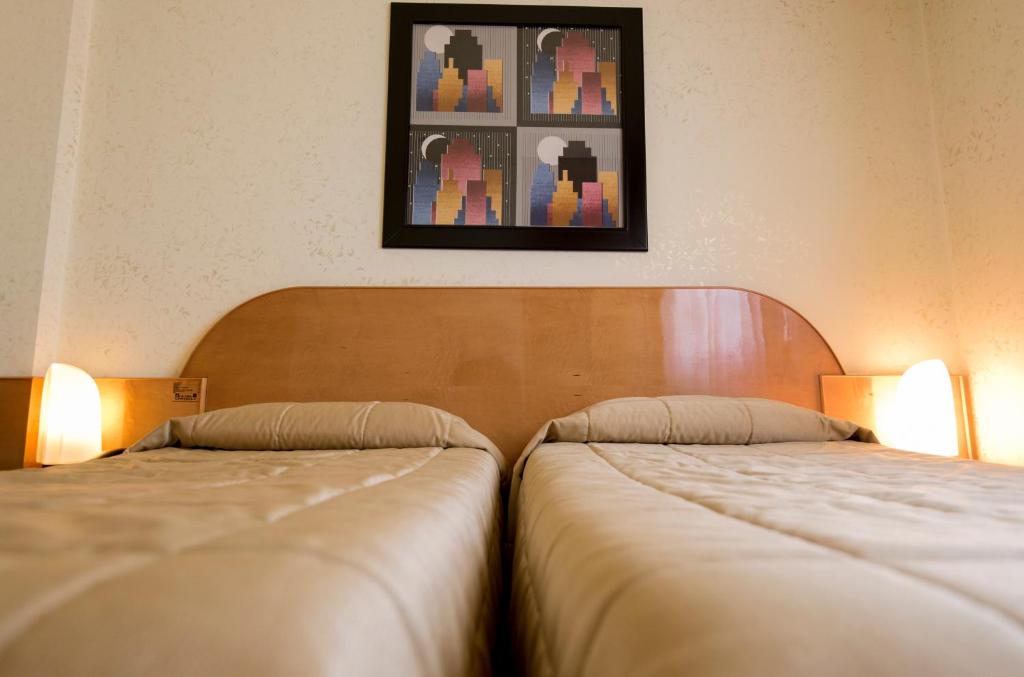 Łóżko lub łóżka w pokoju w obiekcie Hotel Castello Artemide Congressi