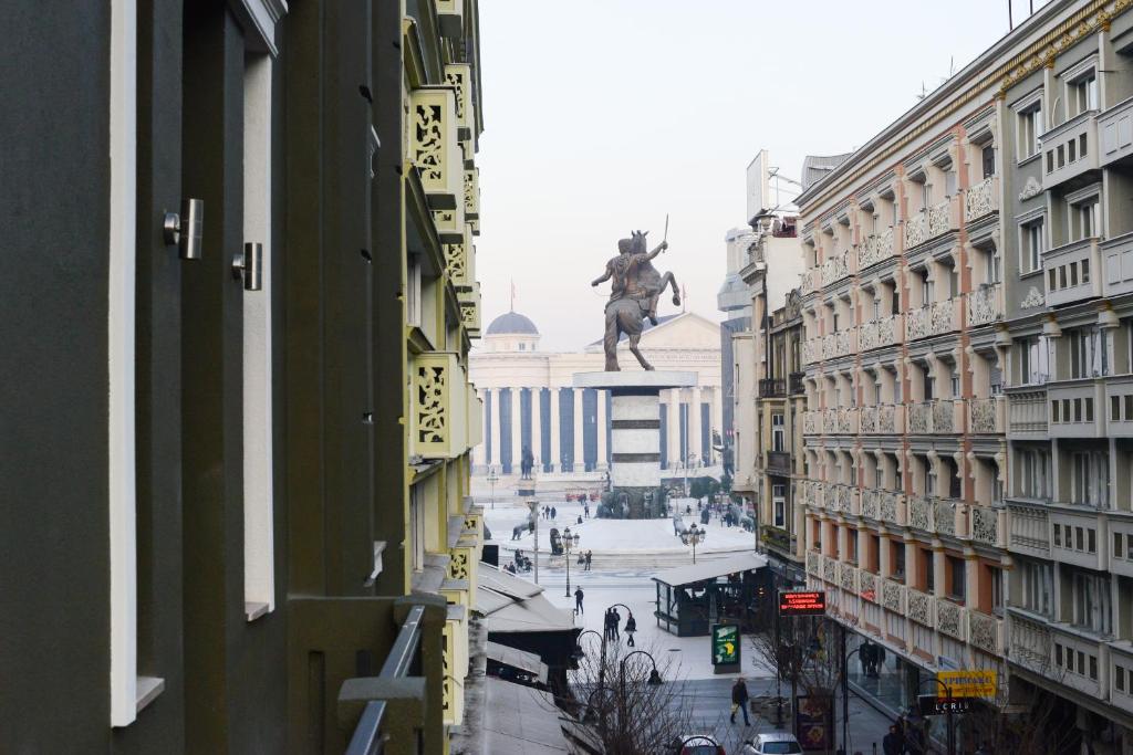 a statue of a man on a horse in a city at Hotel Cara 28 in Skopje