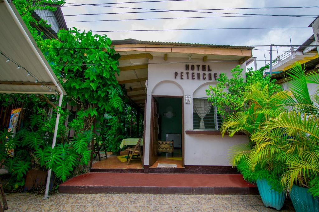 ein kleines weißes Gebäude mit offener Haustür in der Unterkunft Hotel Petenchel in Flores