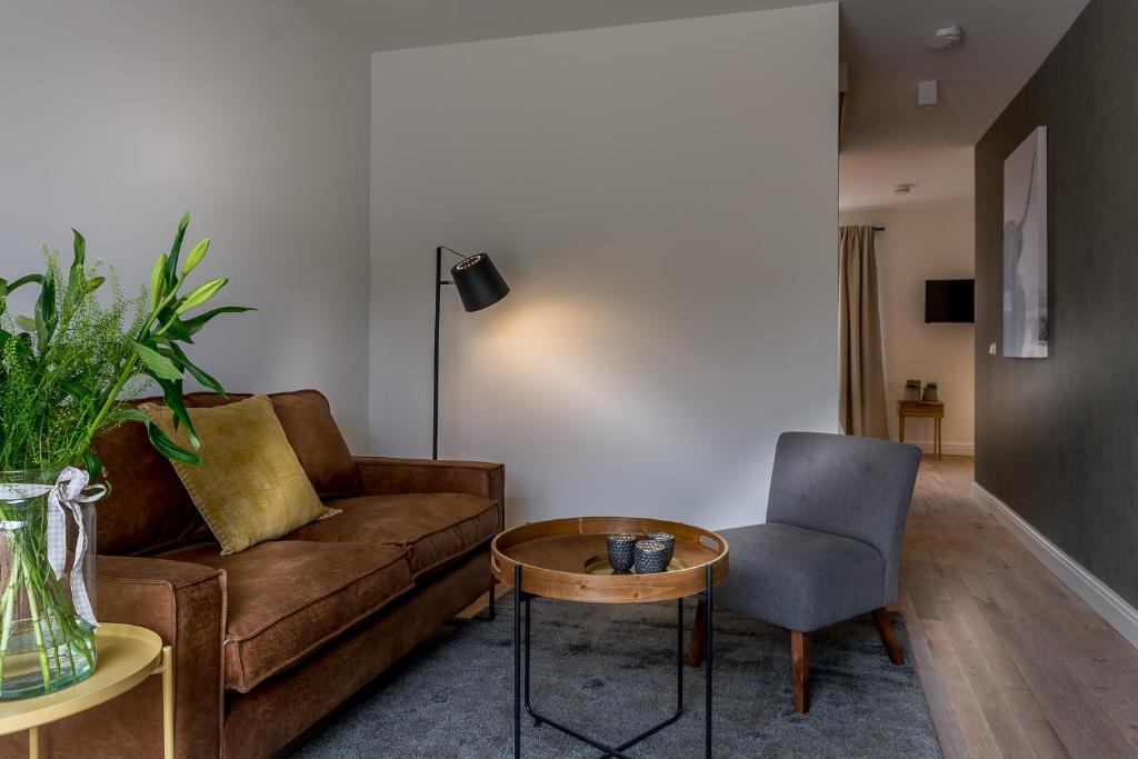 a living room with a couch and a chair at Zoet Valkenburg in Valkenburg