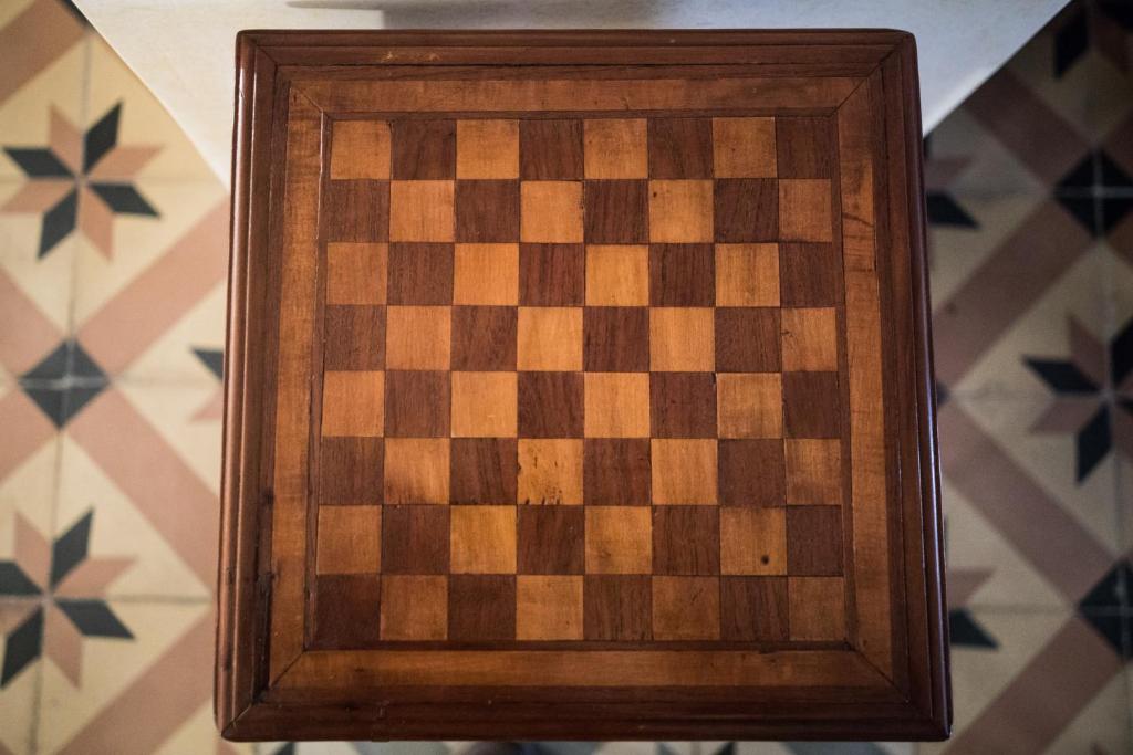 a chessboard in a wooden frame on a wall at Casa Katy in Siena
