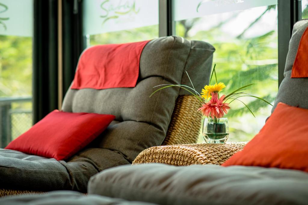 A cushioned lounge seating area beside tall windows.