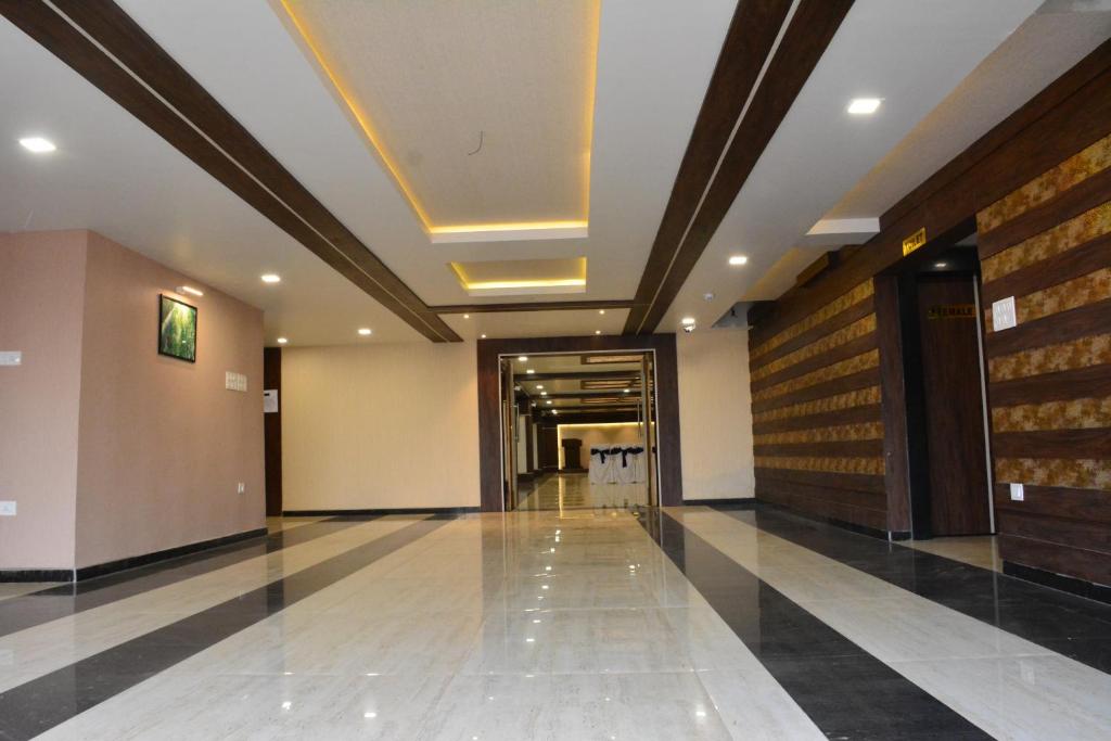 a hallway of a building with a ceiling and a hallway at The Suncity in Bhubaneshwar