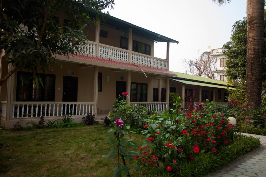 a house with flowers in front of it at Sauraha Resort in Sauraha