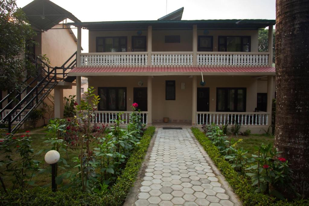 a house with a walkway in front of it at Sauraha Resort in Sauraha