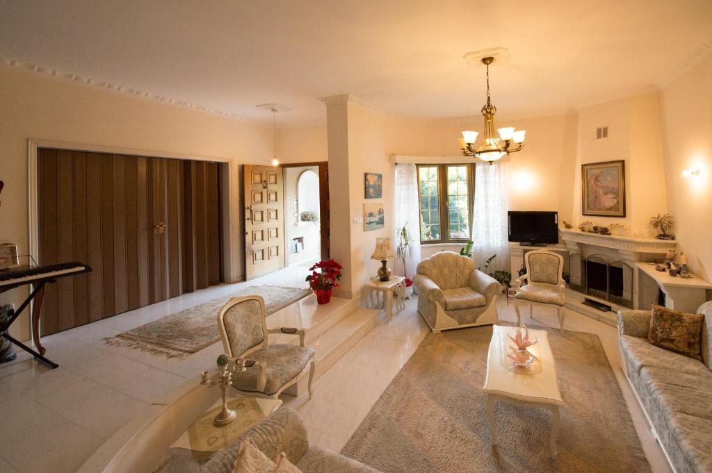 a living room filled with furniture and a chandelier at Kiriaki House in Paphos City