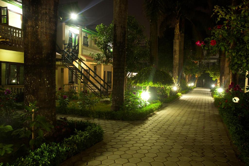 a street at night with trees and lights at Sauraha Resort in Sauraha