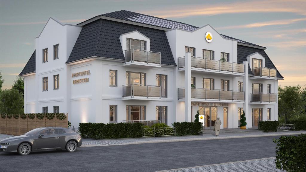 a rendering of a white house with a car parked in front at Aparthotel Bernstein in Büsum