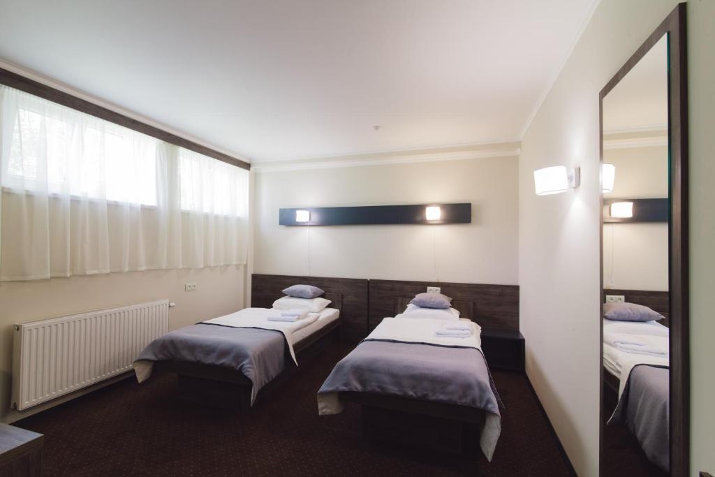 Postel nebo postele na pokoji v ubytování Zinedine Sport-Hotel