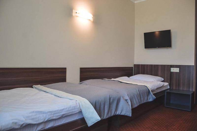 Postel nebo postele na pokoji v ubytování Zinedine Sport-Hotel