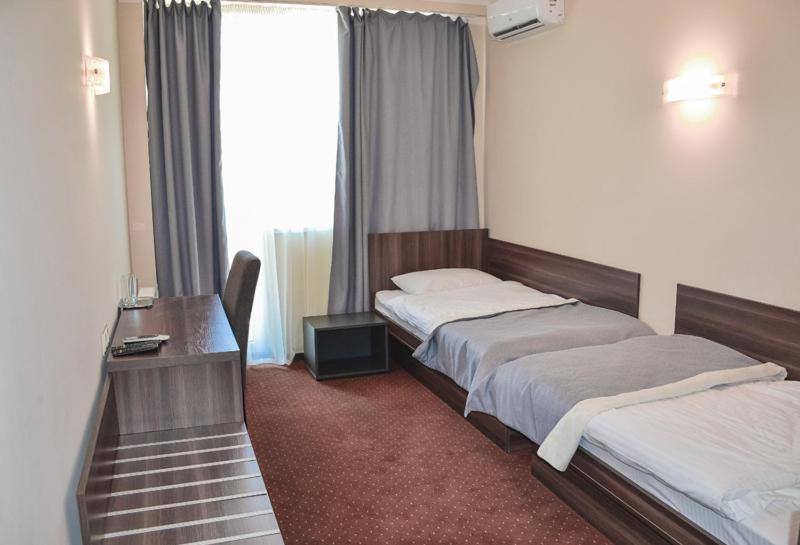Postel nebo postele na pokoji v ubytování Zinedine Sport-Hotel