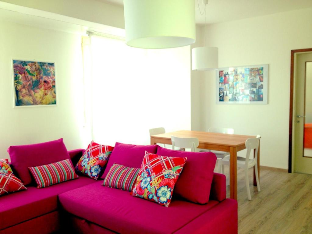 a living room with a red couch and a table at Casa Julia in Cividale del Friuli