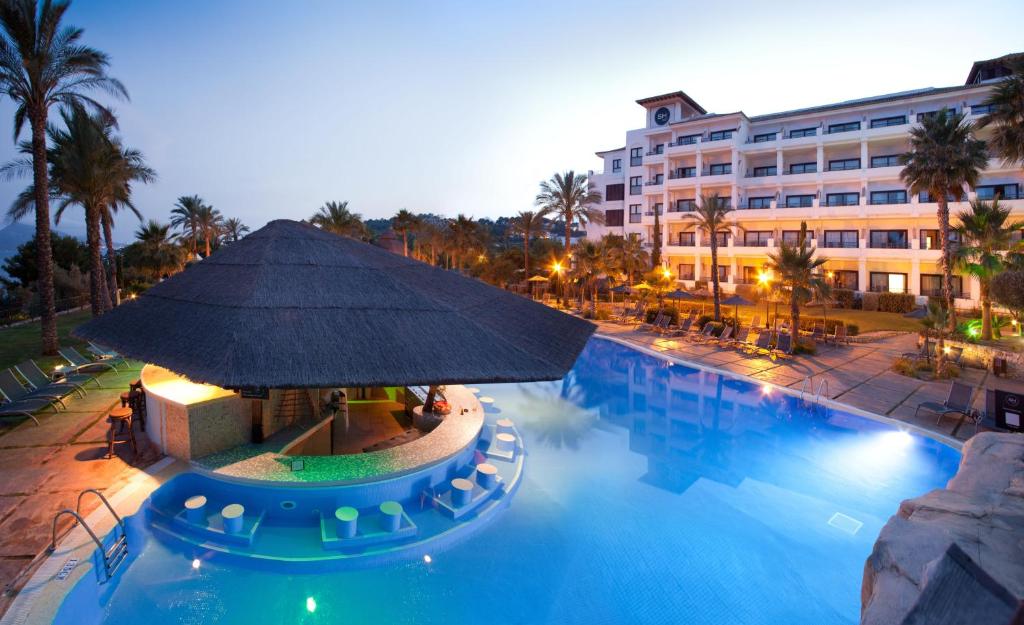 a hotel with a large swimming pool with a large building at SH Villa Gadea in Altea