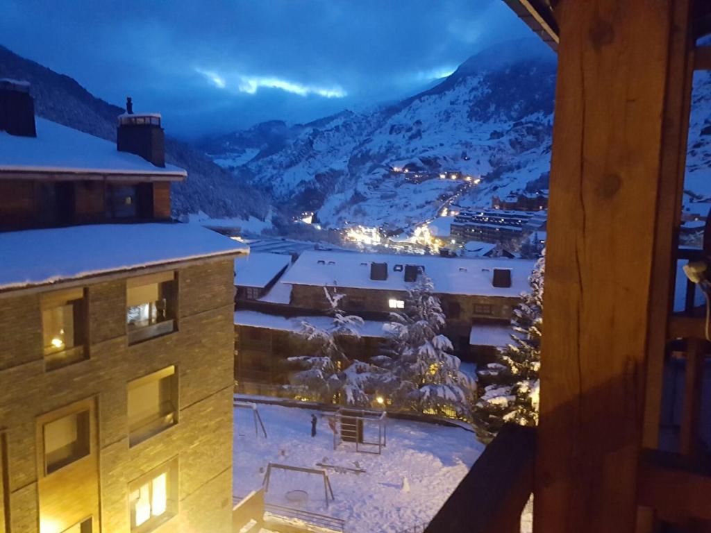 a view from a balcony of a building in the snow at Tarter Cozy studios by Renttarter Sans Espais in El Tarter