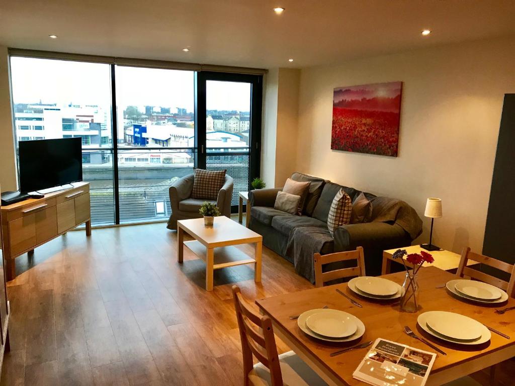 a living room with a couch and a table at River Heights in Glasgow