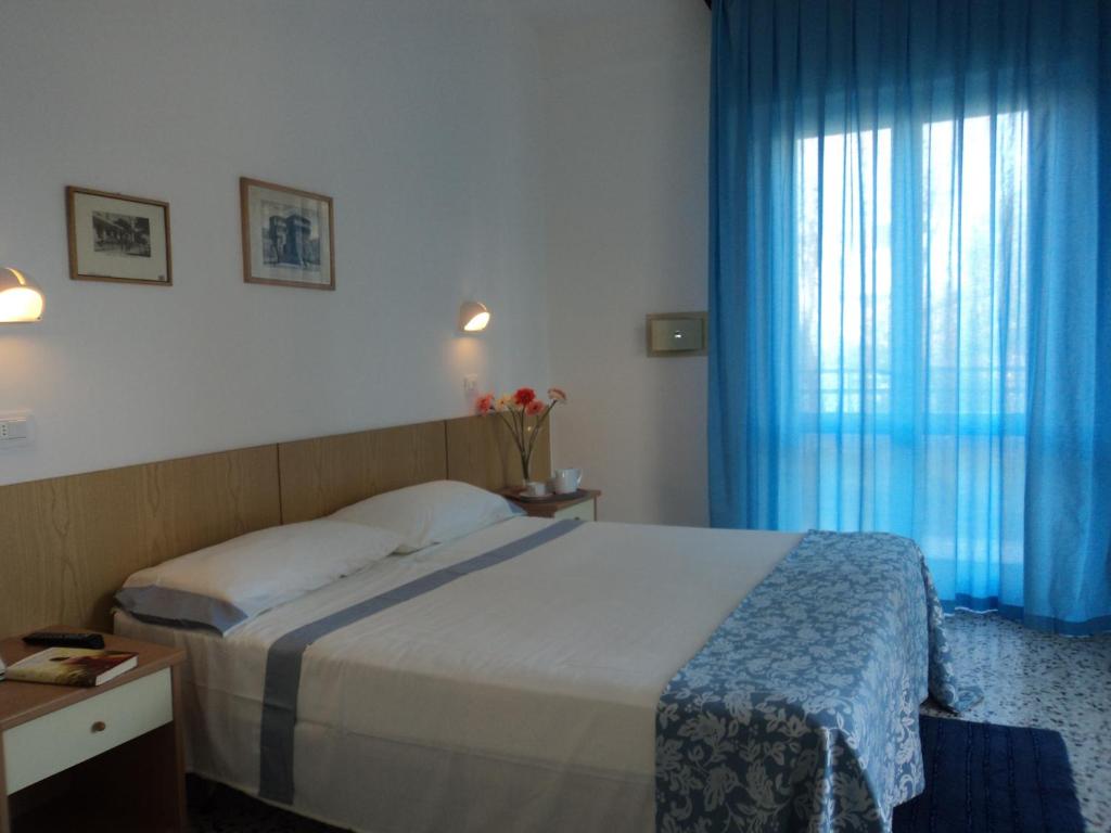 A bed or beds in a room at Hotel Irene
