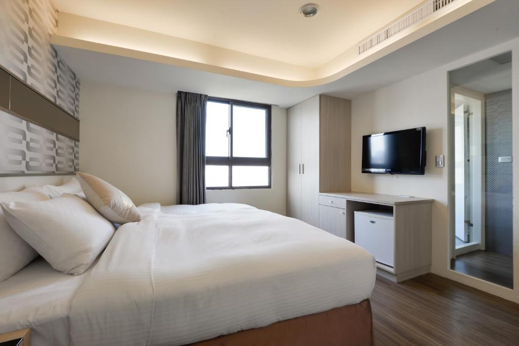 Postel nebo postele na pokoji v ubytování Bonjour Hotel