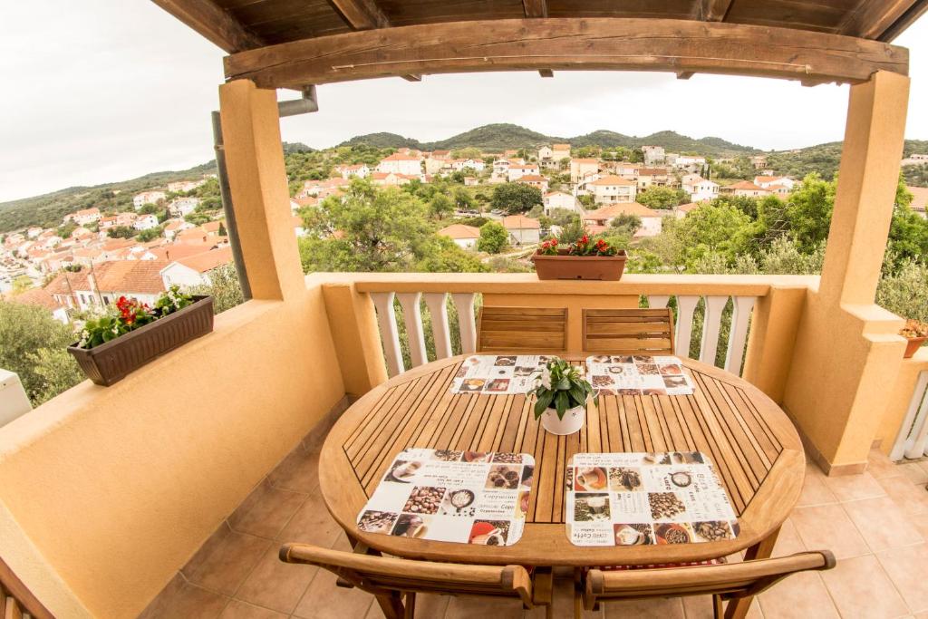a table and chairs on a balcony with a view at House Lucija in Sali