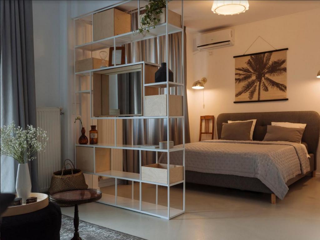 a bedroom with a bed and a book shelf at River View Studio in Bucharest