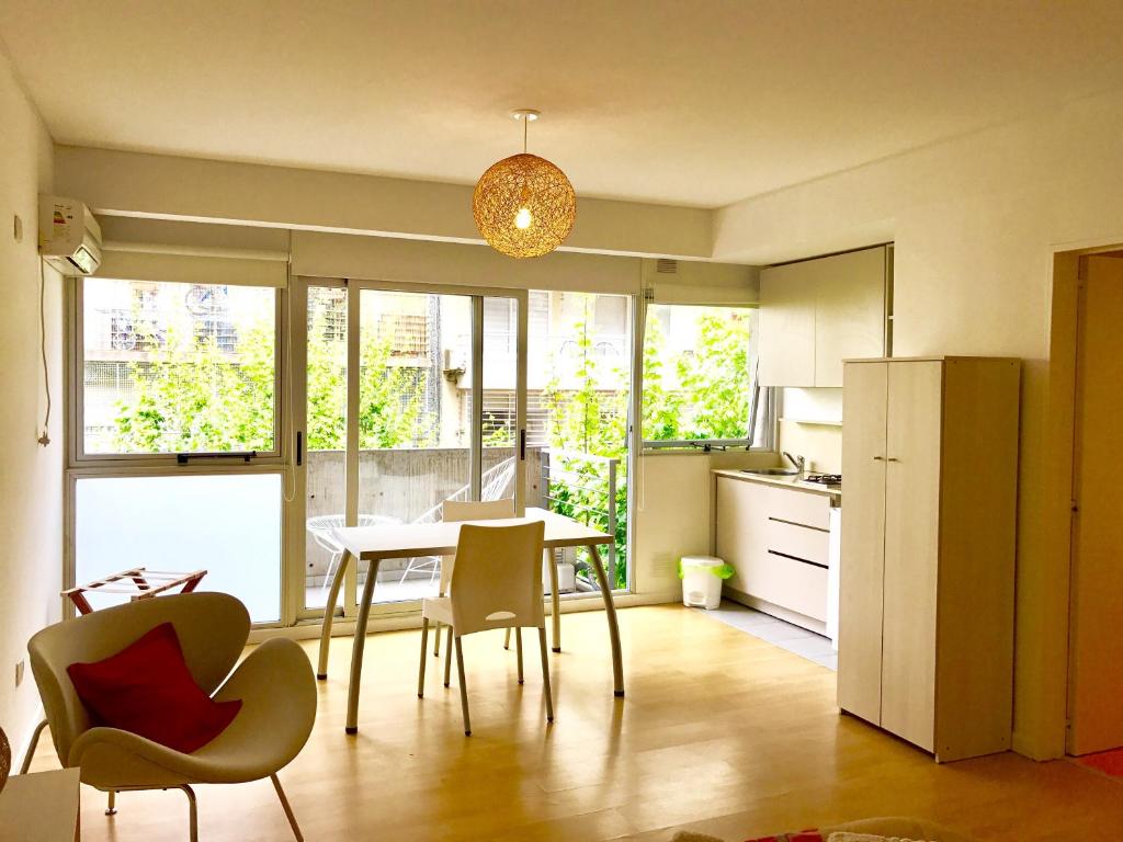 a kitchen with a table and chairs in a room at Ocio Laprida in Buenos Aires