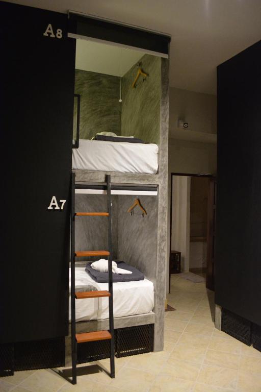 a bunk bed with four bunk beds in a room at Nirvana Guesthouse & Hostel in Koh Tao