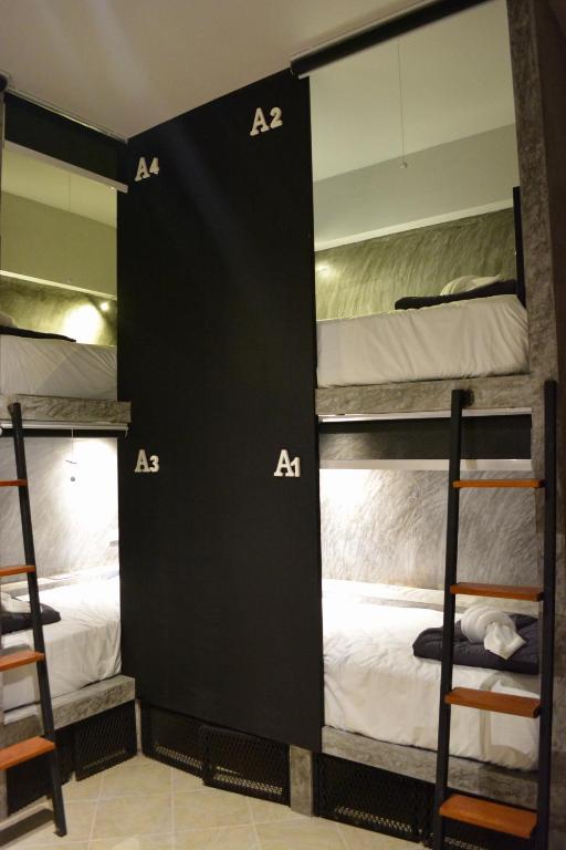 a group of bunk beds in a room at Nirvana Guesthouse & Hostel in Koh Tao