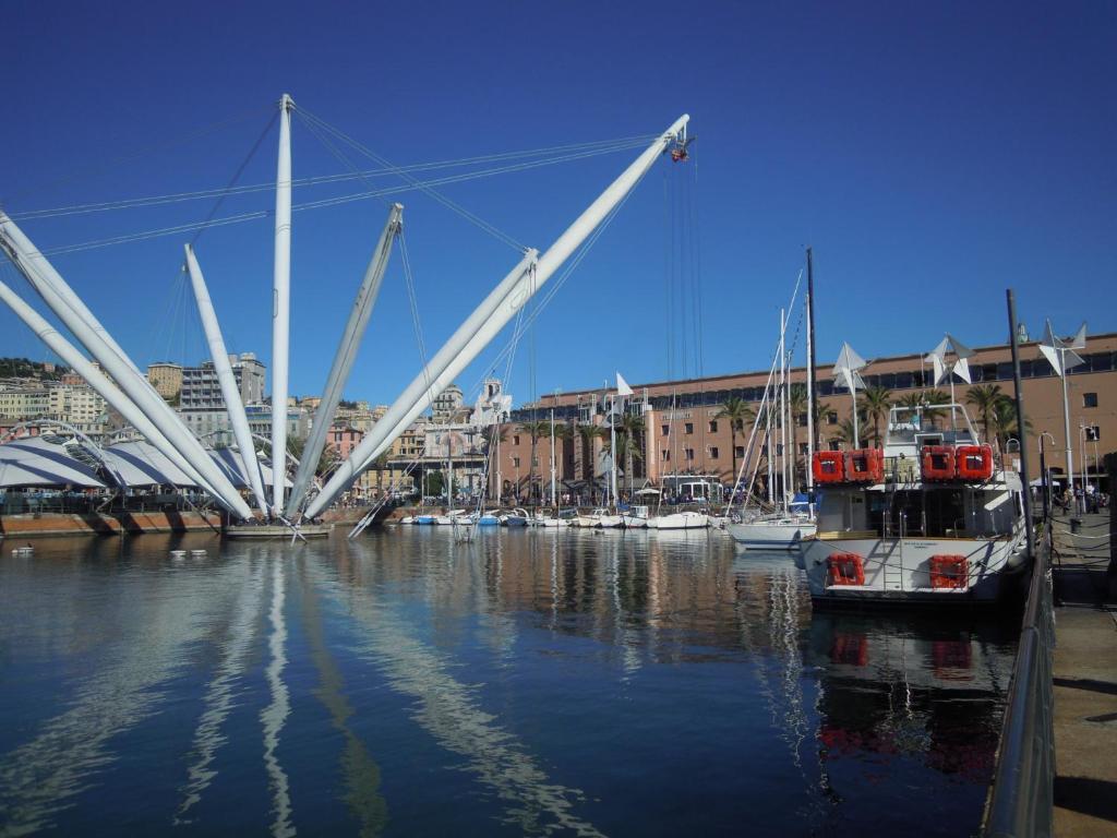 a boat is docked in a harbor with a bridge at Una Porta sul Porto Antico in Genova