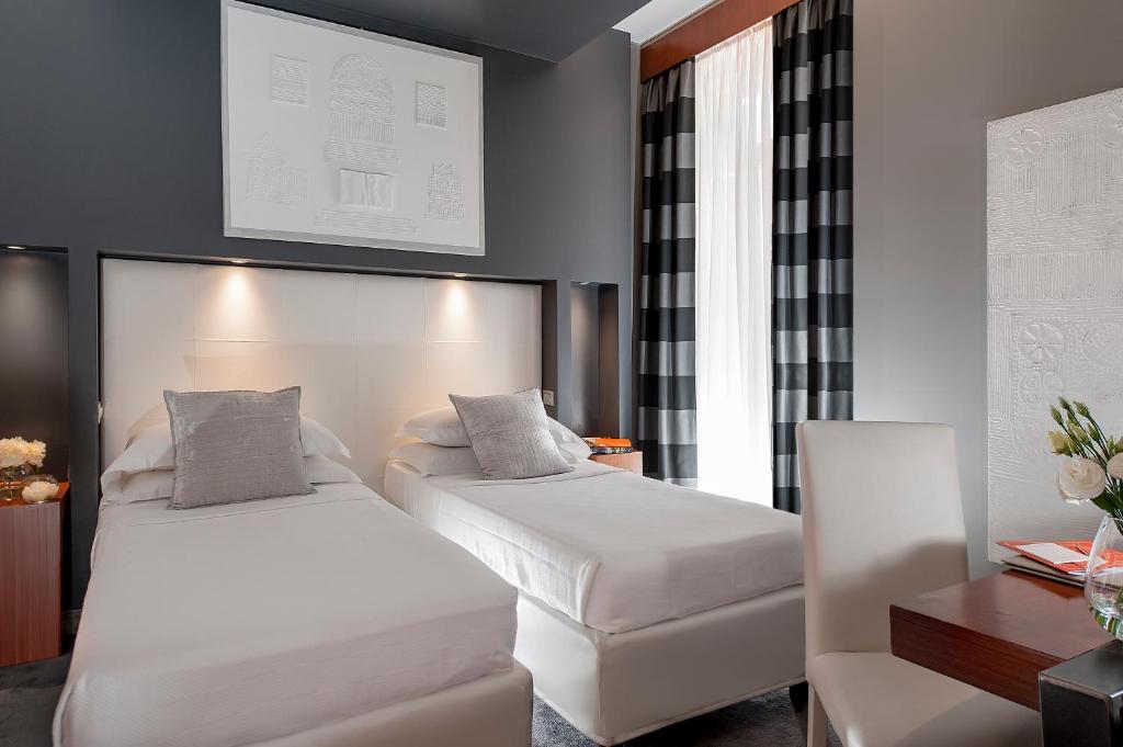 Postel nebo postele na pokoji v ubytování Metropolis - Hotel di Charme