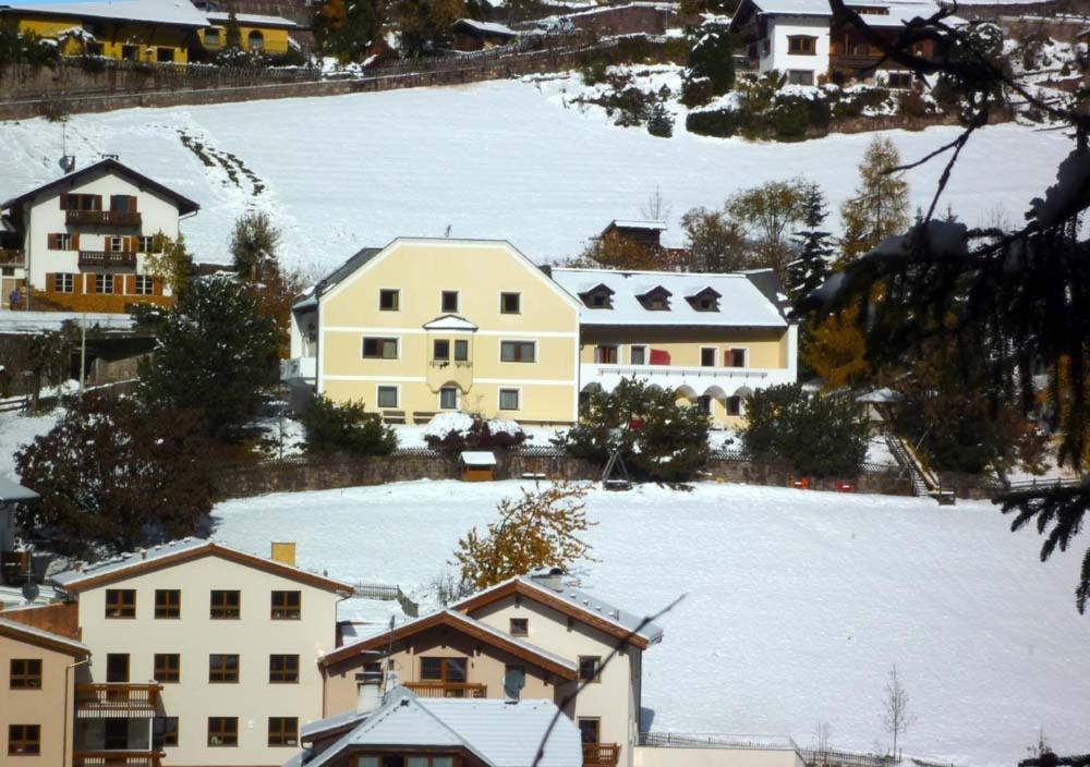 an aerial view of a snow covered village with houses at Residence Granvara in Ortisei