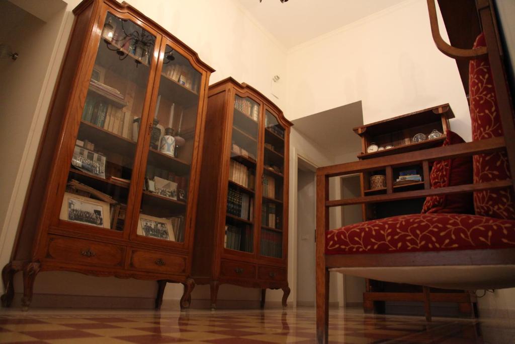 a living room with a wooden cabinet and a chair at B&B Casa Ruffino in Balestrate