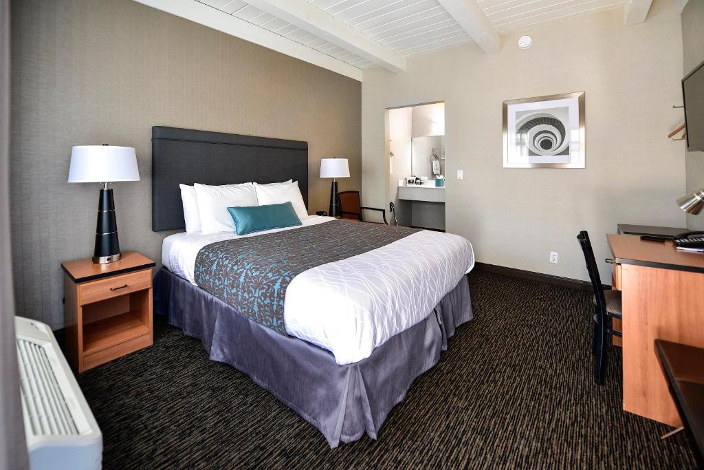 a hotel room with a bed and a desk at City Center Inn and Suites in San Francisco
