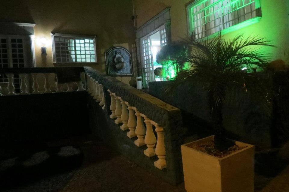 a dark room with a staircase and a potted plant at La Villa Hotel in Cordeirópolis