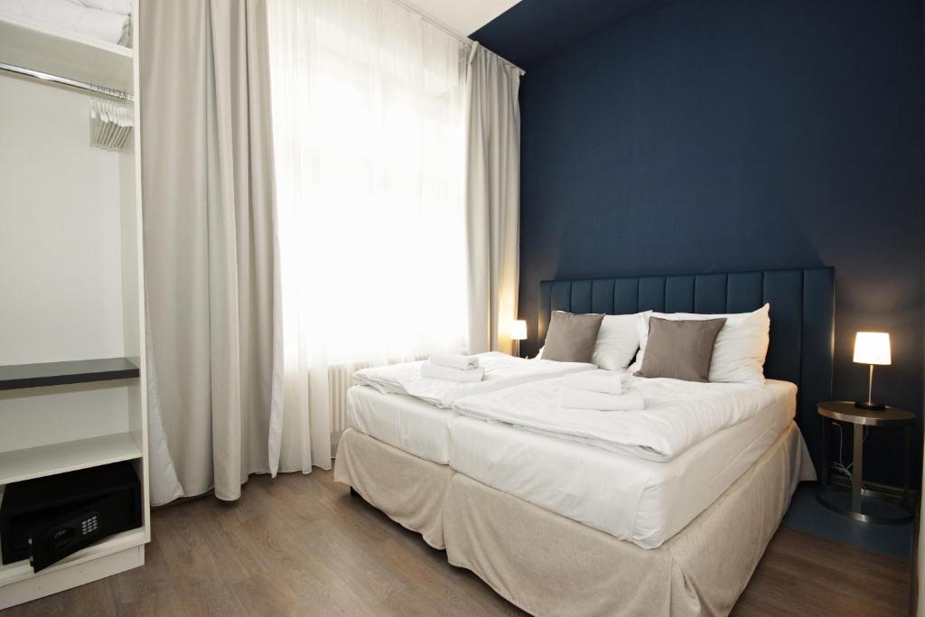 Łóżko lub łóżka w pokoju w obiekcie Alveo Suites