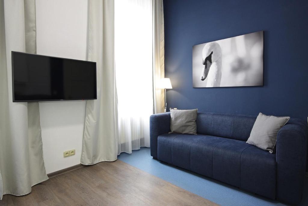 Telewizja i/lub zestaw kina domowego w obiekcie Alveo Suites