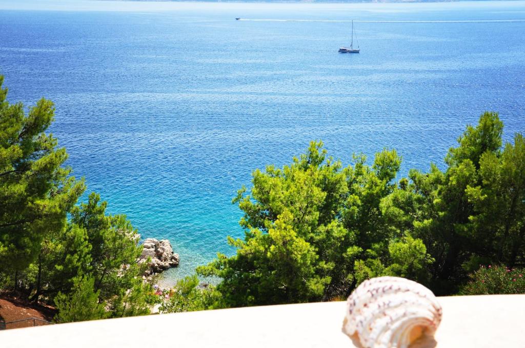 a view of the ocean with a boat in the water at Sunrise Studio Apartments 3 in Lokva Rogoznica