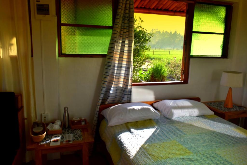 Postel nebo postele na pokoji v ubytování Guerrera Rice Paddy Villas