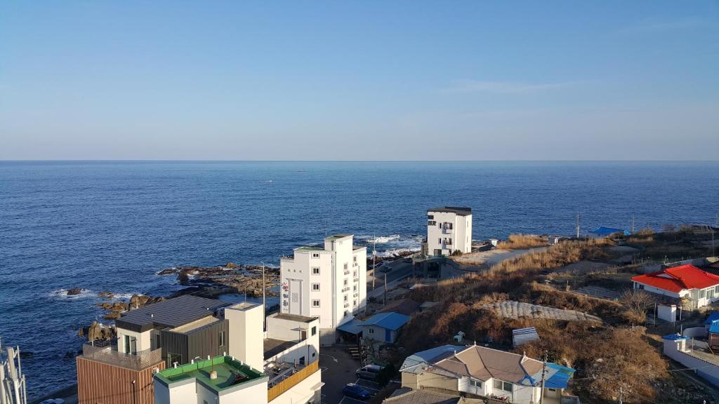an aerial view of a city and the ocean at Haetmom House in Gangneung