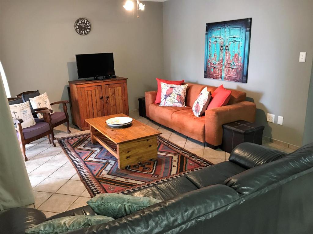 a living room with a couch and a coffee table at Sand & Sea Self-Catering Apartments in Swakopmund