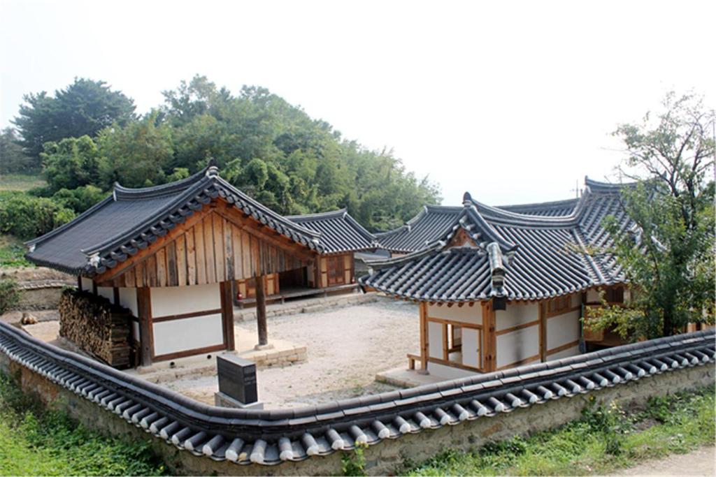 a group of three buildings with black roofs at Dobong Seodang in Gyeongju