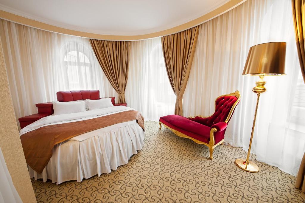 1 dormitorio con 1 cama, 1 silla y 1 lámpara en Spa Resort Vnukovo, en Vnukovo