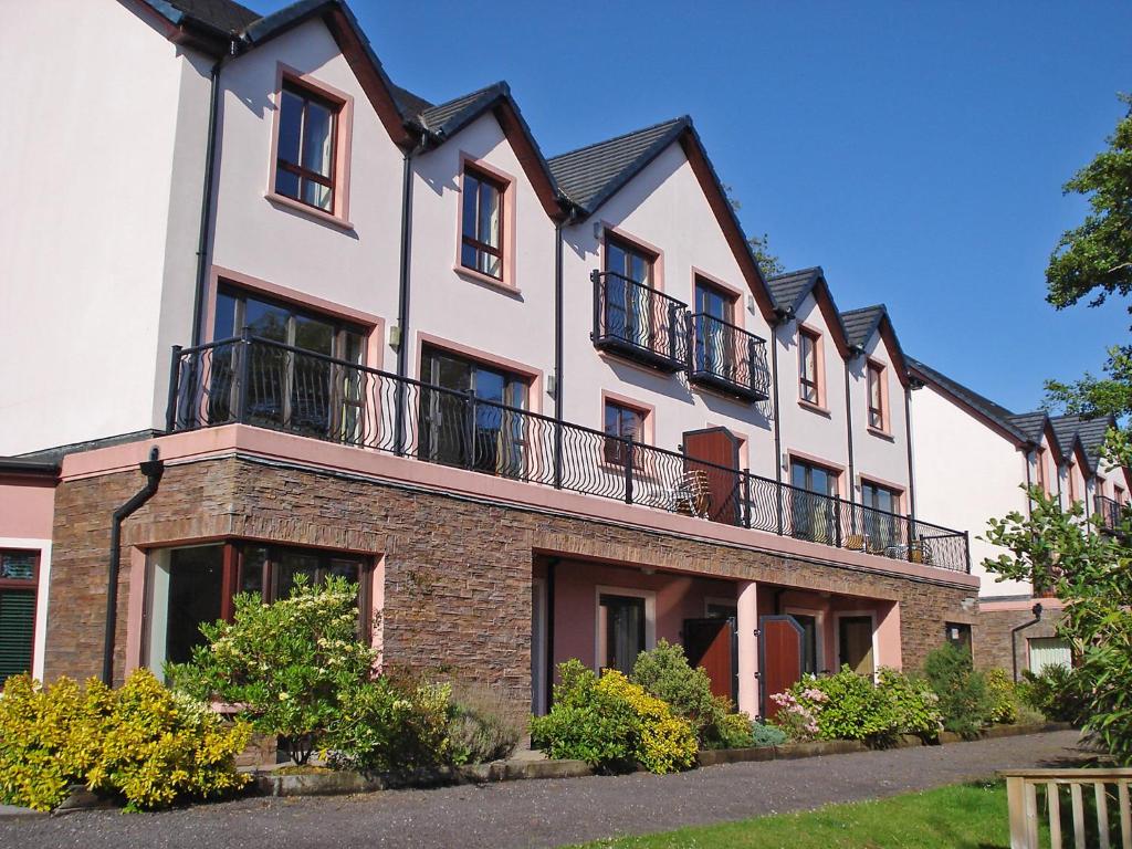 a large house with balconies on top of it at Holiday Home Grove Lodge-2 by Interhome in Killorglin