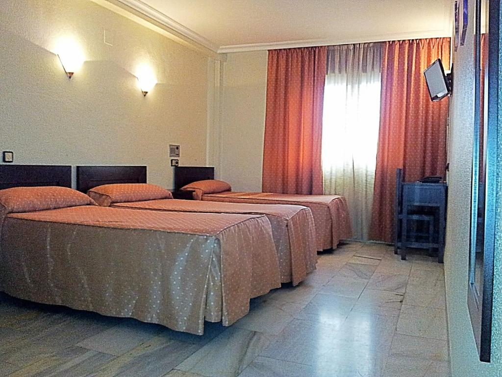 Postel nebo postele na pokoji v ubytování Hotel Averroes