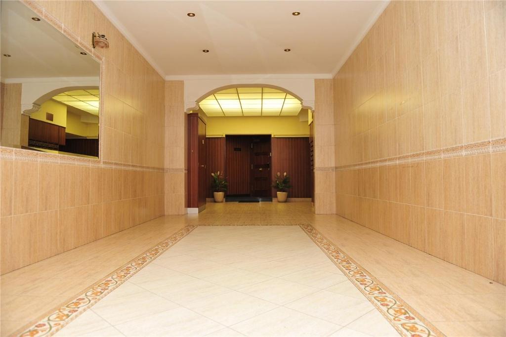 a hallway of a building with wooden walls and mirrors at Pensión Ariz in Basauri