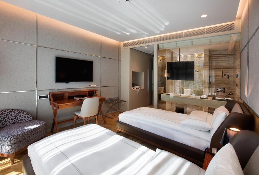 a hotel room with two beds and a desk at Fer Hotel in Istanbul