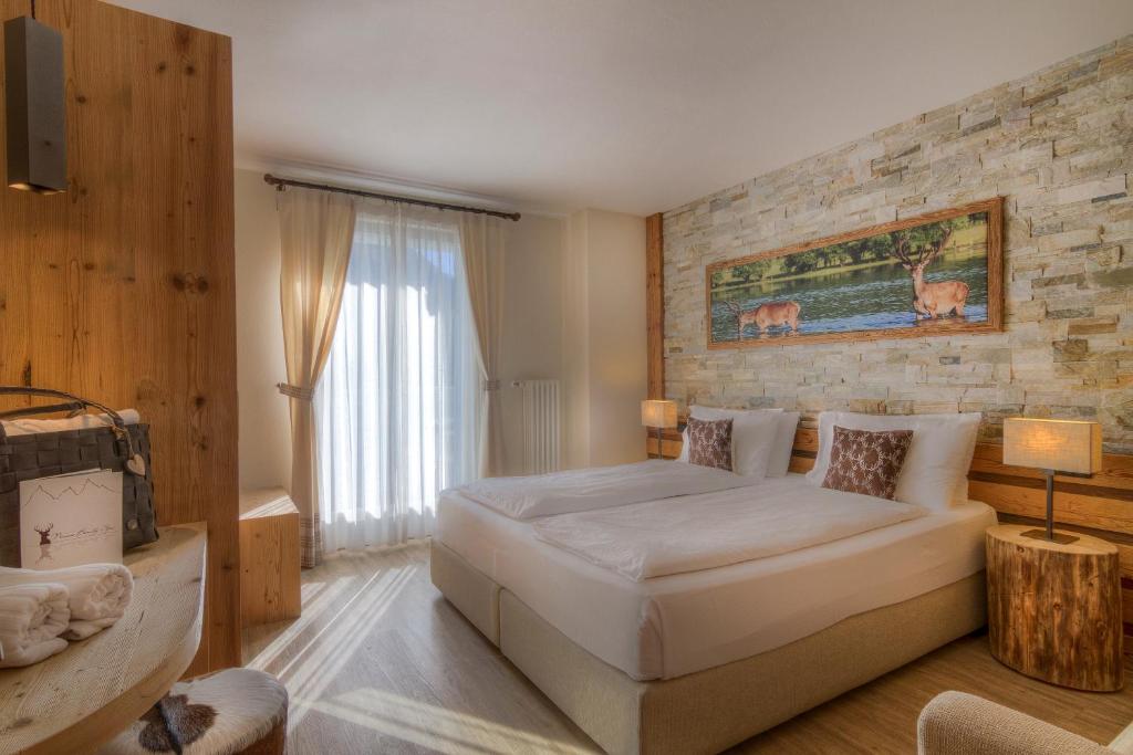 Postel nebo postele na pokoji v ubytování Hotel Madonnina Resort And Wellness