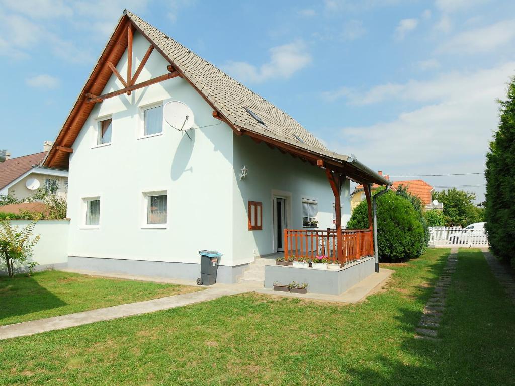 a white house with a gambrel roof at Holiday Home Greenie by Interhome in Balatonszárszó