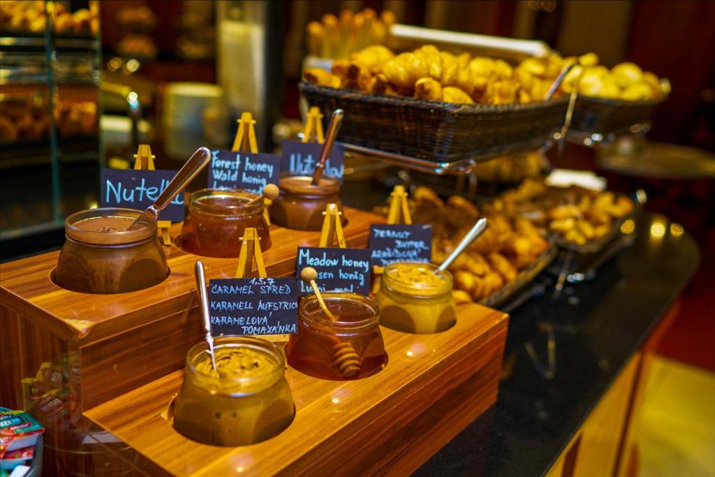 a display of honey and other food items on a counter at Don Giovanni Hotel Prague - Great Hotels of The World in Prague