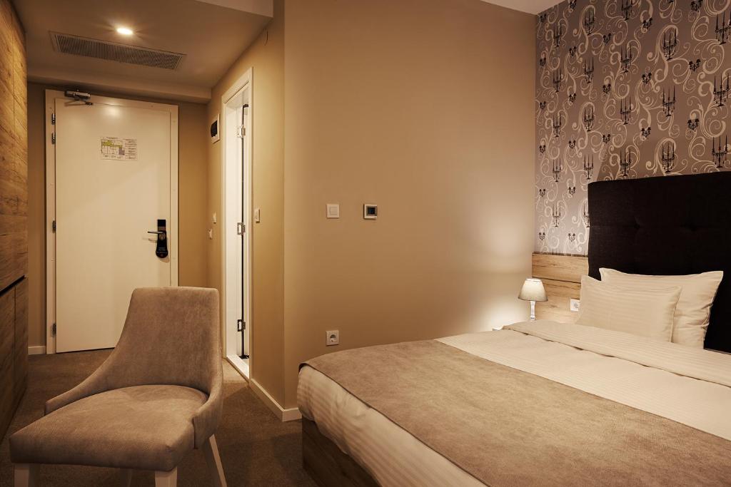 Postel nebo postele na pokoji v ubytování IG Hotel