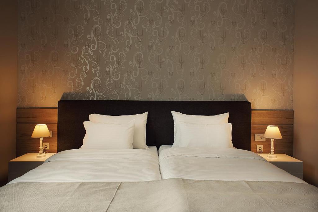 Postel nebo postele na pokoji v ubytování IG Hotel