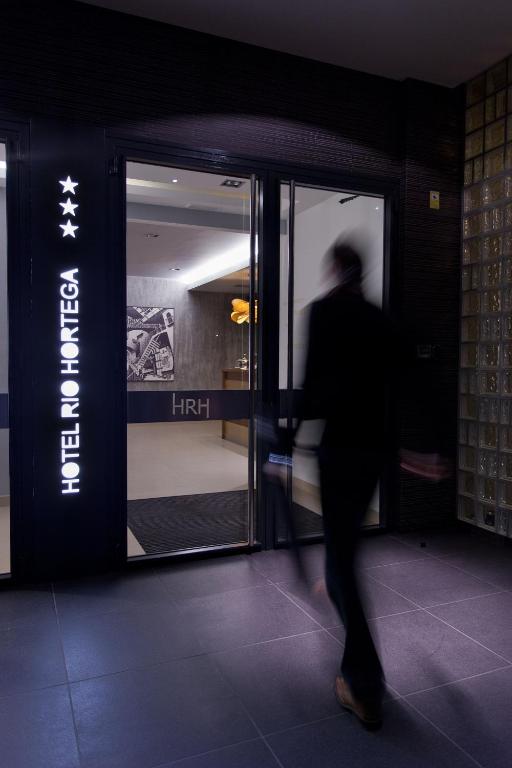 a person walking into a store with its doors open at Hotel Río Hortega in Valladolid